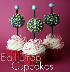 three cupcakes are decorated with sprinkles and candy