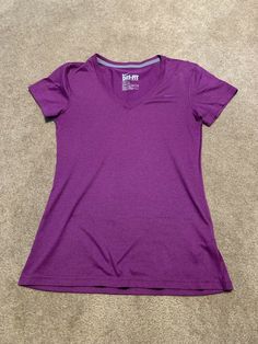 This Nike shirt is in excellent condition. It is a size XS and is a pretty purple color. Smoke free home. Fitted Nike Purple Tops, Nike Casual V-neck Top, Purple Short Sleeve Workout Top, Purple Sporty T-shirt For Workout, Casual Purple V-neck Shirt, Purple Sporty Workout T-shirt, Purple Workout T-shirt, Nike Shirts, Dri Fit