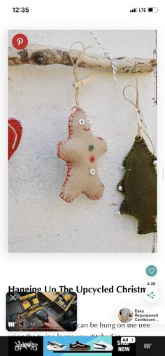 a christmas ornament hanging from a twig on the wall next to other ornaments