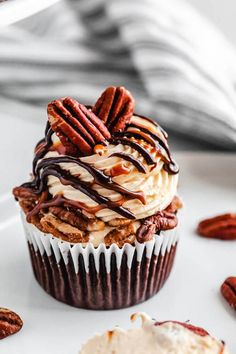 a cupcake with chocolate and pecans on top