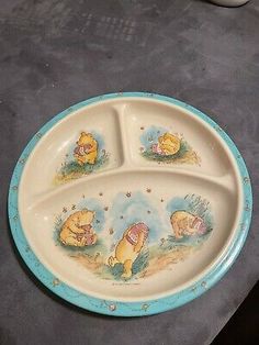 a winnie the pooh plate with three sections