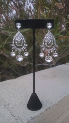 "These fun and stylish rhinestone long chandelier earrings make a statement. Great statement piece! Pageant, prom, or bridal! Size of earrings: 1.5\" wide and 3.5\" Long. Color: Clear Rhinestones Base Metal color: silver Style: Pierced Need a matching bracelet? https://www.etsy.com/listing/767597835/clear-rhinestone-stretch-bracelet?ref=shop_home_active_31 https://www.etsy.com/listing/600792630/clear-rhinestone-bracelet-rhinestone?ref=shop_home_active_67&frs=1 https://www.etsy.com/listing/74 Pageant Earrings, Bridal Statement Earrings, Long Chandelier, Bridal Earrings Chandelier, Bridal Clip, Crystal Chandelier Earrings, Prom Earrings, Rhinestone Bridal, Earrings Crystal