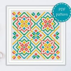 a cross stitch pattern with scissors and thread on the table next to it is an image of