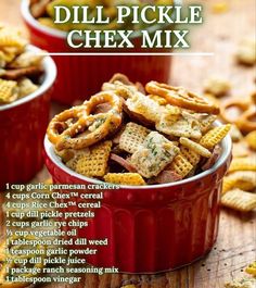 two red bowls filled with chex mix on top of a wooden table