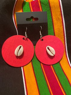 Hand painted wooden earring with cowrie shell Traditional Earrings For Beach Summer, Traditional Summer Beach Earrings, Wooden Beads Earrings For Beach, Wooden Beaded Earrings For Beach, Beach Wooden Bead Earrings, Red Round Beach Earrings, Red Round Earrings For Beach, Red Shell Jewelry For Gifts, Red Shell Jewelry As A Gift