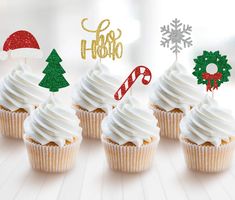 cupcakes with white frosting and christmas decorations