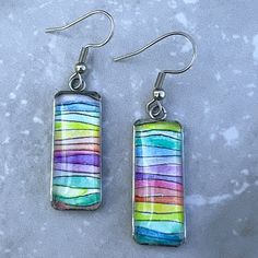 Rectangular hand-painted rainbow watercolor earrings. Watercolor Resin Jewelry, Artsy Resin Dangle Earrings, Multicolor Resin Dangle Jewelry, Watercolor Earrings, Fun Multicolor Resin Earrings, Multicolor Teardrop Resin Earrings, Watercolor Jewelry, Multicolor Glass Drop Earrings, Alcohol Ink Jewelry