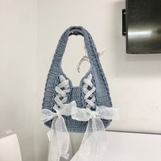 a crocheted purse hanging on the wall