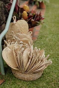 two baskets are sitting on the grass next to each other with decorative items in them