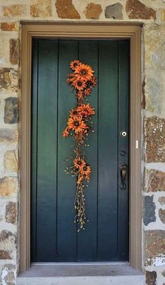 an orange flower is hanging on the front door