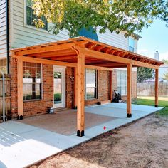 an outdoor covered patio in front of a house