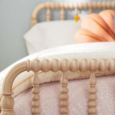 a close up of a bed with a wooden headboard and foot board on it