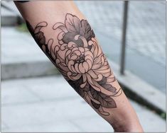 a person with a flower tattoo on their arm