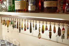 a shelf filled with bottles and glasses on top of a counter