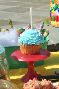 cupcakes with butterflies on them sitting on a table