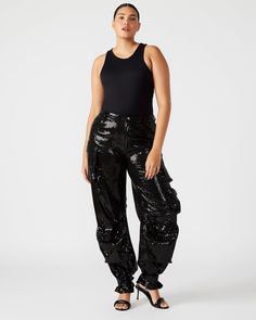 Expertly designed for a structured and voluminous fit, the DUO sequin pant is crafted from midweight cotton twill fabric. With adjustable ankle straps, these wide leg cargo pants offer a versatile silhouette that can be easily customized to your preference. Mid rise sequin cargo pants Zipper fly with shank button closure Two side pockets, two back patch pockets, and five cargo pockets down the legs Bottom three cargo pockets feature extended zipper pulls Snap strap at hem to cinch ankles Unlined Black Sequin Pants, Industrial Glam, Sequin Pant, Wide Leg Cargo Pants, Football Game Outfit, Steve Madden Store, Apparel Merchandising, Shank Button, Performance Wear