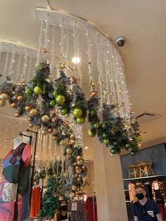 christmas decorations hanging from the ceiling in a store