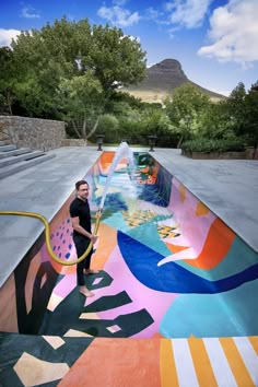 a man standing in front of a colorful pool