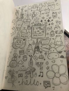 an open notebook with doodles on it and various items in the pages that are drawn