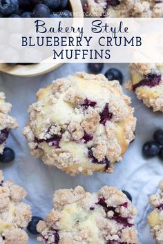 blueberry crumb muffins on a white surface with fresh blueberries in the background