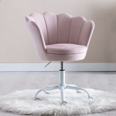 a pink office chair sitting on top of a white rug in front of a wall