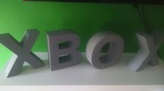 the letters are made out of foam and placed next to each other in front of a green wall