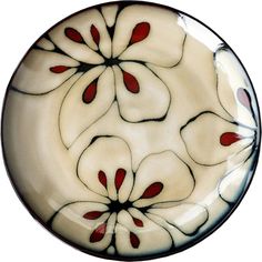 a white plate with red and black flowers on it