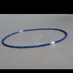 This Vibrant Blue Necklace Was Set Up Using 3.5 Mm Faceted Lapis Lazuli Rondelles, Sterling Silver Findings And A Natural White Pearl. Materials: ~ 3.5 Mm Lapis Lazuli Faceted Rondelles ~ White Natural Round Pearl. ~ Sterling Silver Findings ~ 16” Inches Long Plus 1” Inch Extender Chain Lapis Lazuli Is An Ancient Stone, Used For Manifestation, Wisdom, Truthfulness, Openness, Communication, Inner Power, Intuition, Spiritual Evolution, Virility, Self-Confidence, Objectivity, Dreams, Purity, Sereni Adjustable Blue Pearl Necklace With Gemstone Beads, Blue Lapis Lazuli Pearl Necklace Gift, Elegant Sapphire Crystal Necklaces With Round Beads, Elegant Sapphire Faceted Beaded Necklaces, Elegant Sapphire Round Beads Crystal Necklace, Elegant Blue Lapis Lazuli Beaded Necklaces, Blue Single Strand Round Pearl Necklace, Elegant Blue Crystal Necklaces With Gemstone Beads, Elegant Blue Gemstone Bead Crystal Necklace