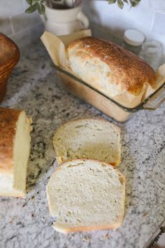 sliced loaf of bread sitting on top of a counter next to another loaf of bread