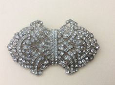 "marked: Tara Clear rhinestone Art Deco style vintage brooch size: 3\" x 1.75\" Very good to excellent vintage condition" Antique Rhinestones Brooch For Vintage Events, Antique Rhinestone Brooches For Vintage Events, Antique Rhinestone Brooches For Party, Vintage Sparkling Wedding Brooches, Glamorous Rhinestone Wedding Brooches, Vintage Crystal Embellished Brooches For Formal Events, Glamorous Formal Brooches With Rhinestones, Glamorous Formal Brooches With Bling, Silver Art Deco Brooches For Wedding