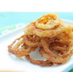 some onion rings are on a white plate