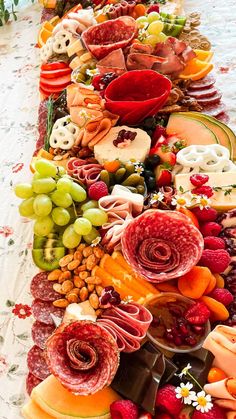 a very long table with many different types of food on top of it, including fruits and vegetables