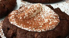 chocolate cookies with white frosting and sprinkles