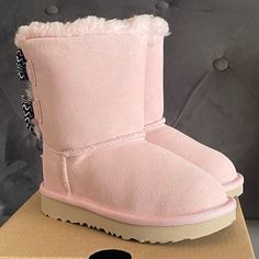 Ugg Bailey Bow Toddler Boots Pink Color Brand New & Comes With Original Box Multiple Sizes Available 7 Toddler And 8 Toddler 100% Autthentic, Bought From Ugg Store This Take On The Popular Bailey Bow Features An Artistic Squiggle-Striped Pattern For Playful Pop Of Color And Texture. It's Built For Kids On The Move With A Super-Lightweight Outsole For Traction And Durability. Responsibly Sourced Materials Include Recycled Polyester Binding And Uggpure Upcycled Wool Insole. Treadlite By Ugg Propri Black Glitter Boots, Toddler Uggs, Holiday Boots, Ugg Bailey Boots, Toddler Ugg Boots, Grey Uggs, Ugg Bailey Bow, Pink Core, Ugg Store