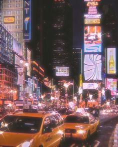 a city street filled with lots of traffic and tall buildings covered in neon signs at night