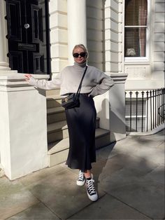 Turtle Neck Sweater And Skirt Outfit, Black Silk Midi Skirt Outfit Winter, Black Satin Midi Skirt Outfit Casual, Black Silk Midi Dress Outfit Winter, Long Silk Skirt Outfit Winter, Silk Skirt And Sneakers Outfit, Black Satin Skirt With Sweater, Sweater And Satin Skirt Outfit, Winter Satin Skirt Outfit