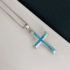 "Sterling silver blue opal cross necklace, opal is the October birthstone. Beautiful blue opal necklace with chain.  Cross blue opal pendant made with sterling silver. A free silver chain is included (18 inches). ✨ For free giveaways, special offers and latest design updates, simply follow us on Facebook and Instagram ✨ - www.facebook.com/chenmafinejewellery - www.instagram.com/chenmafinejewellery I choose to use opal because it enkindles optimism, enthusiasm and creativity, and allows for the r Blue Sterling Silver Crucifix Jewelry, Blue Sterling Silver Cross Pendant Necklace, Blue Sterling Silver Cross Necklace Gift, Free Giveaways, Inner Work, Blue Opal Necklace, Cosmic Consciousness, Catholic Images, Necklace Opal