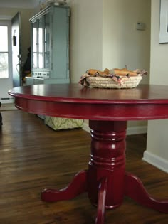 a red table with a basket on top