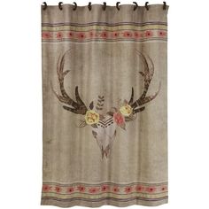 a shower curtain with an animal skull and flowers on it