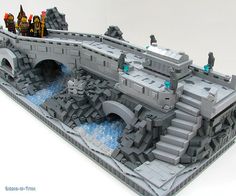 a lego model of a bridge with people on it