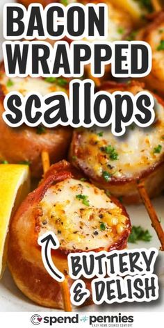 bacon wrapped scallops on a plate with lemon wedges