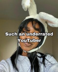 a woman wearing a bunny ears hat with the words, such an underrated youtubeber