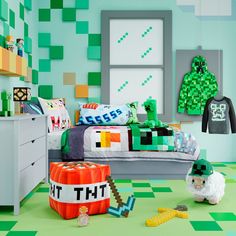 a bedroom decorated in green and white with legos on the walls, bedding and rugs