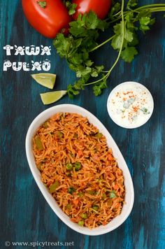 mexican rice with tomatoes and cilantro in a white bowl on a blue table