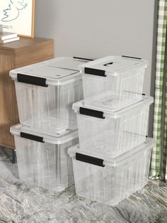 four plastic storage containers stacked on top of each other