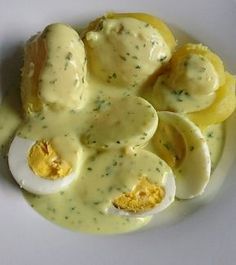 an image of eggs with cheese sauce on a plate for dinner or appetizer