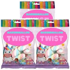 three bags of marshmallows with two unicorn stuffed animals in the front and one on