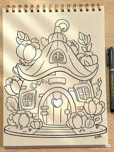 a drawing of a house with fruits and flowers on it next to a marker pen