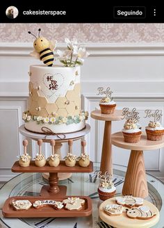 a table topped with cakes and cupcakes covered in frosting