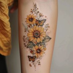 a sunflower and butterfly tattoo on the leg